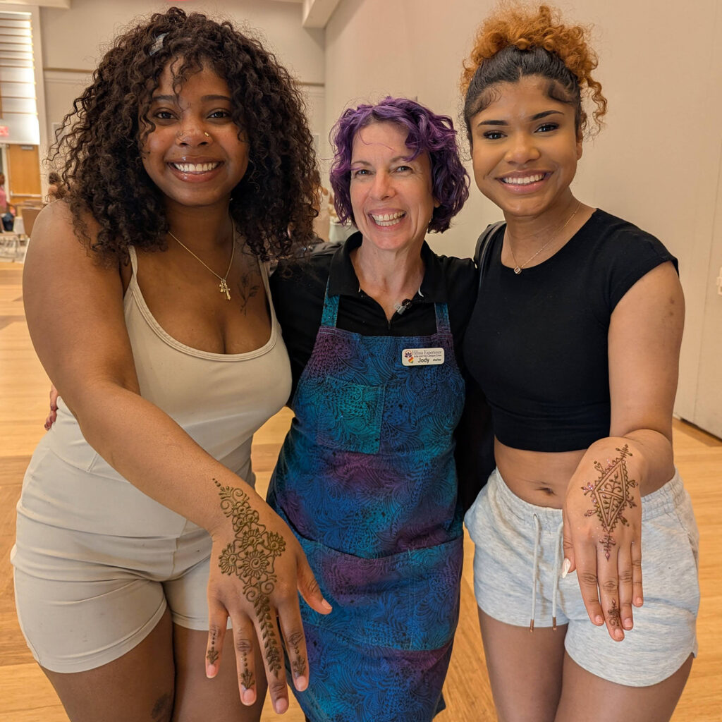 Henna Experience artist, Jody with two students showing off their henna.