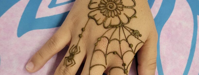 Halloween henna design with a creepy flower, spider, and spiderweb