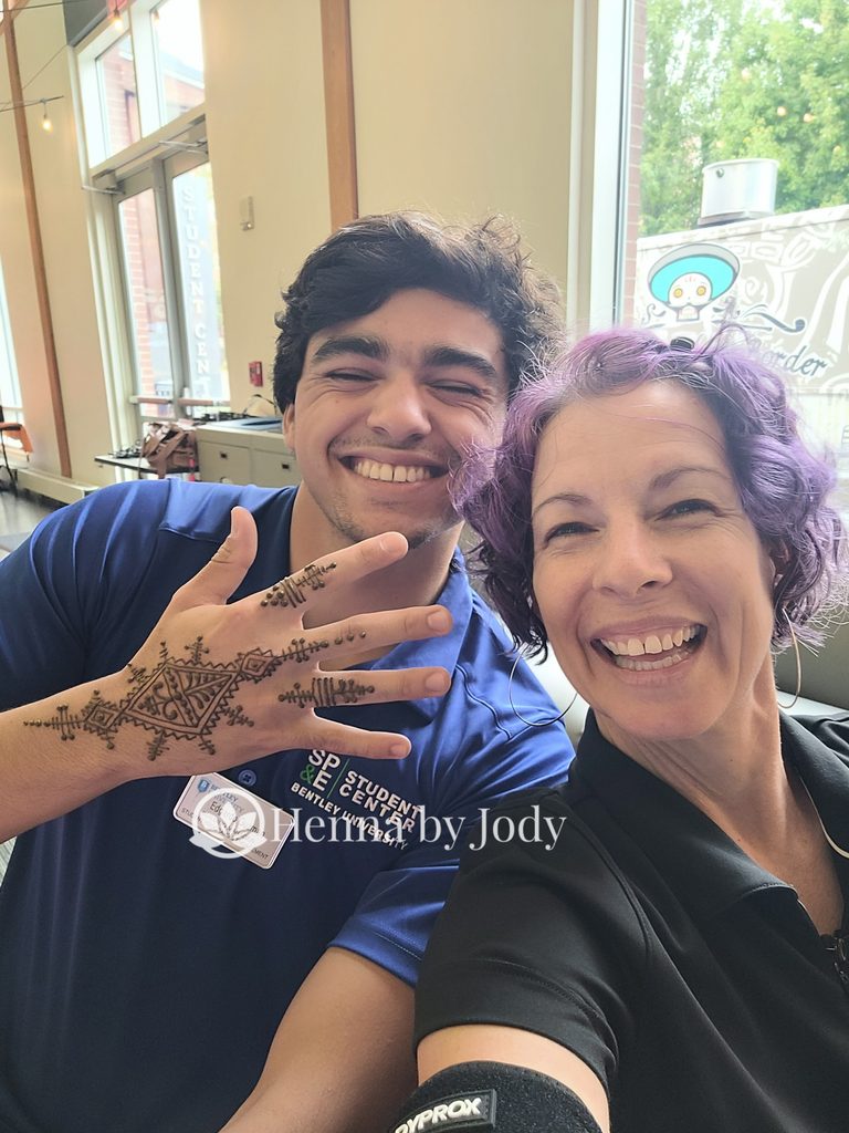 Henna artist, Jody, with student showing off a Moroccan henna design.